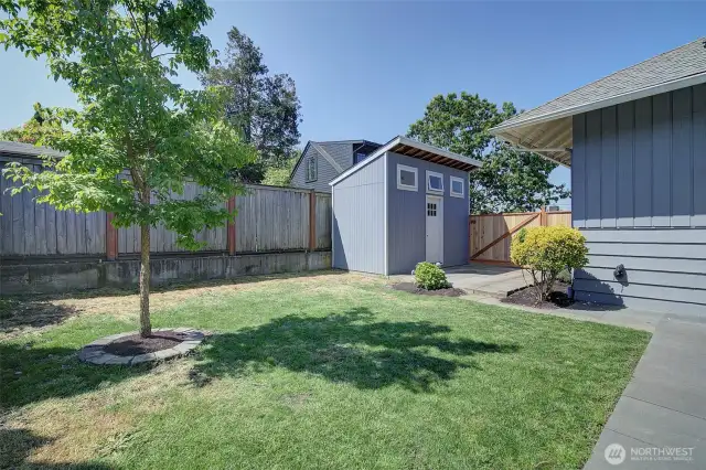 Spacious rear yard also has lawn or garden space, and lofted shed for additional storage.