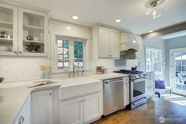 Beautifully appointed kitchen with quartz counters, stainless appliances, and wine storage.