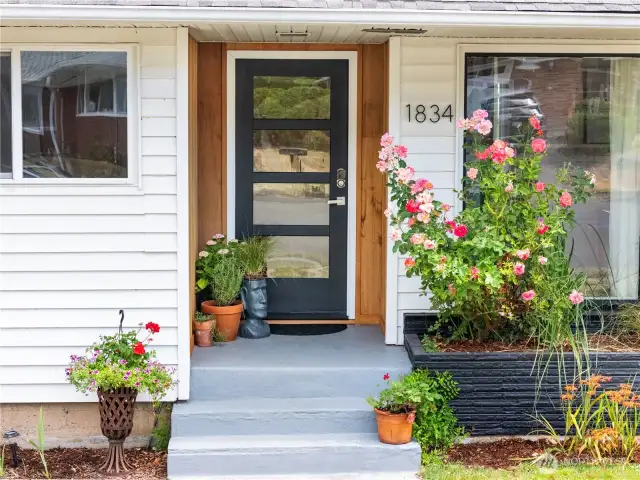 Inviting front stoop with new craftsman style door offers a warm welcome for friends and guests.