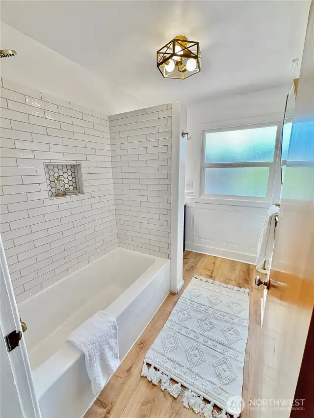 Updated hall bath with new tile surround.