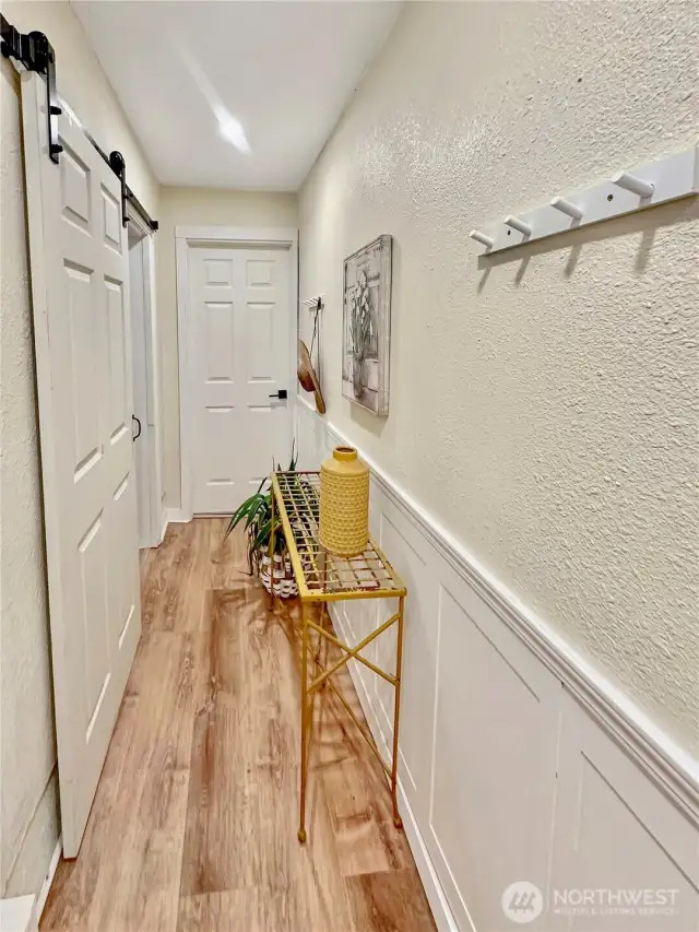 The hall just off the garage offers access to both the main floor and lower level.