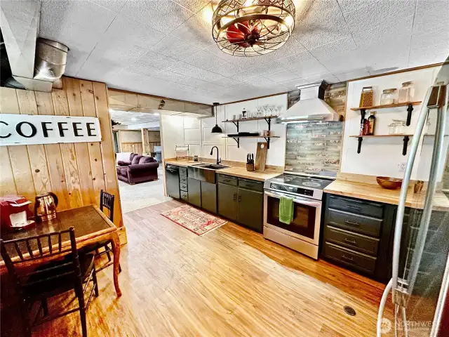 Lower level 2nd kitchen.  Wonderful space updated with wood counters, stainless appliances and open shelves.