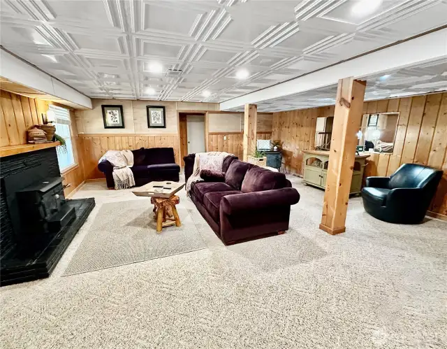 Large family room with wood burning insert. There is also a heat pump that keeps the home cool in the summer and warm in the winter.
