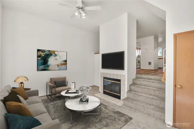 Living room with wood-burning fireplace (virtually staged).