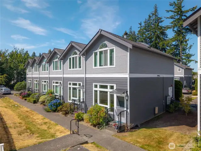 Architecturally interesting townhouses with front lawns and decks in back.