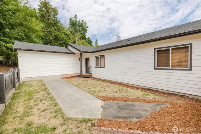 Two-car garage with additional parking space and low-maintenance yard