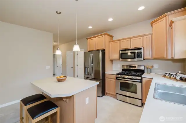 Well-equipped kitchen with stainless steel appliances and ample cabinetry