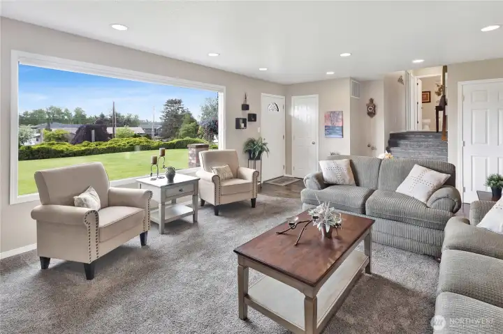 This shot highlights the staircase leading up to the upstairs bedrooms and bathrooms, while the door on the right provides access to the basement.