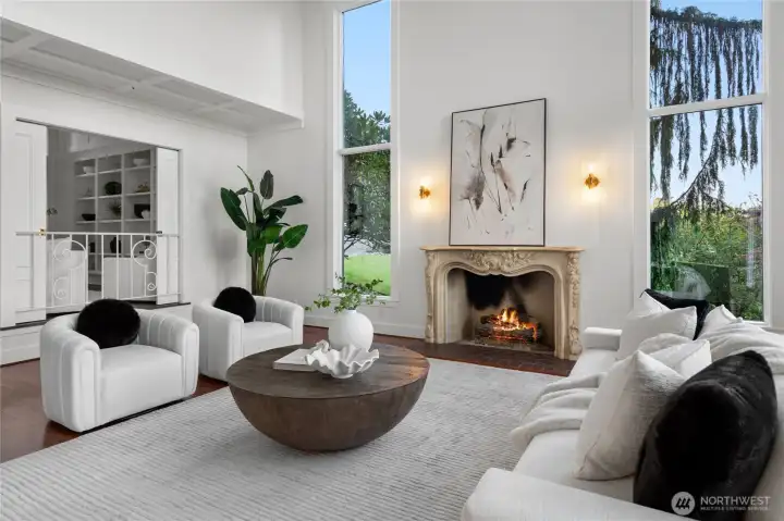 This great room is flooded with natural light thanks to the nearly floor to ceiling windows, yet still stays cozy with the gas fireplace