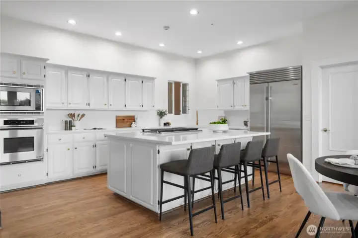 Open concept kitchen has been recently updated with a new gas stove, new trash compactor, and quartz countertops