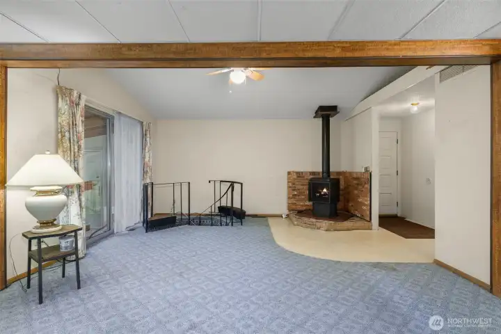Cozy gas fireplace in the living room.  Sunroom to the left and the entry is there on the right