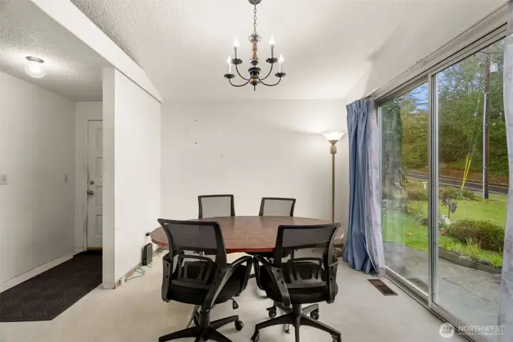 Peek-a-boo water views off the dining room, includes slider door to another patio.