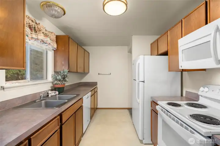 Plenty of storage in this kitchen.  At the end, there's another entrance to the bathroom and bedrooms