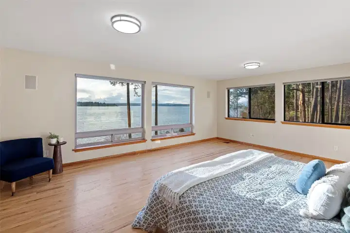 Main-floor primary suite featuring expansive windows and stunning views.
