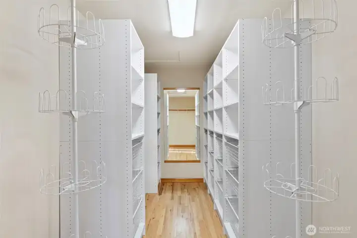 Large walk-in closet with built-in shelving and ample storage.