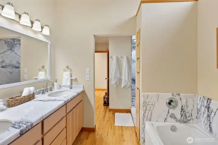 Primary bathroom with thoughtfully designed pocket-door water closet, accessible from both the suite and guest areas.