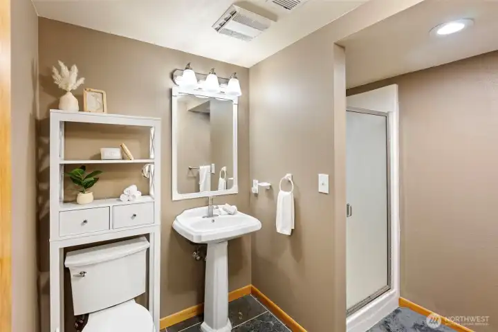 Daylight basement 3/4 bathroom providing convenient access for the lower-level bedrooms.