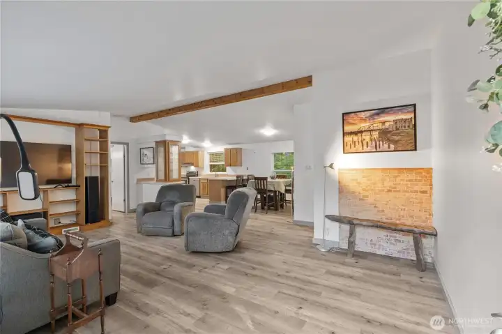 Entrance to living room, open concept floor plan flowing to dining/kitchen