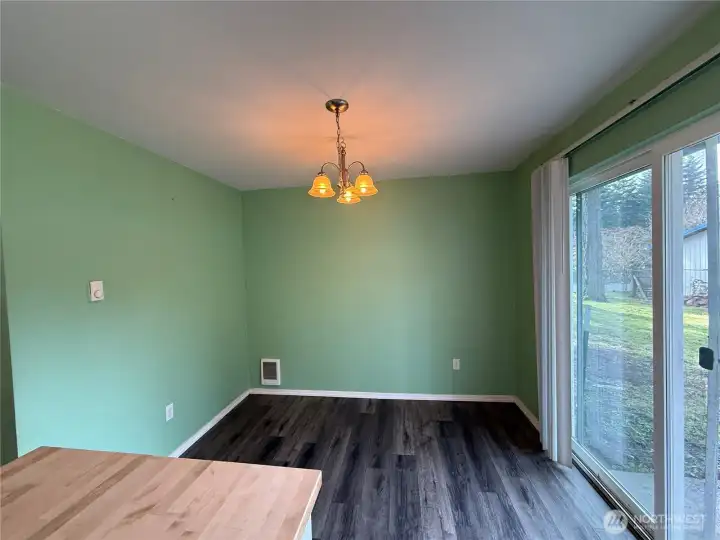 Dining area with slider leading to backyard