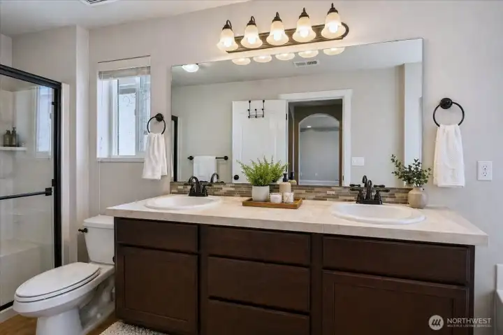 Primary bathroom with dual vanity and separate shower.