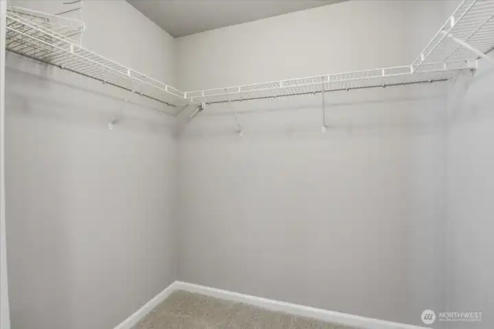 Walk in closet in primary bedroom.