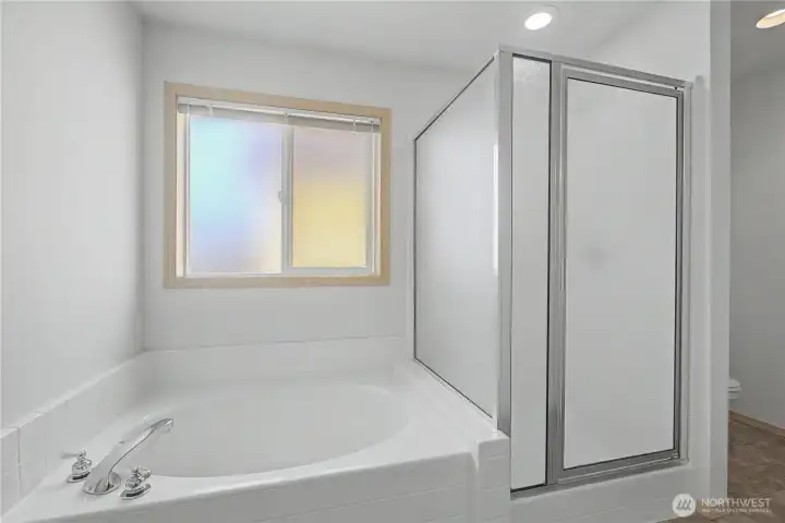 Primary ensuite soaking tub and shower. =