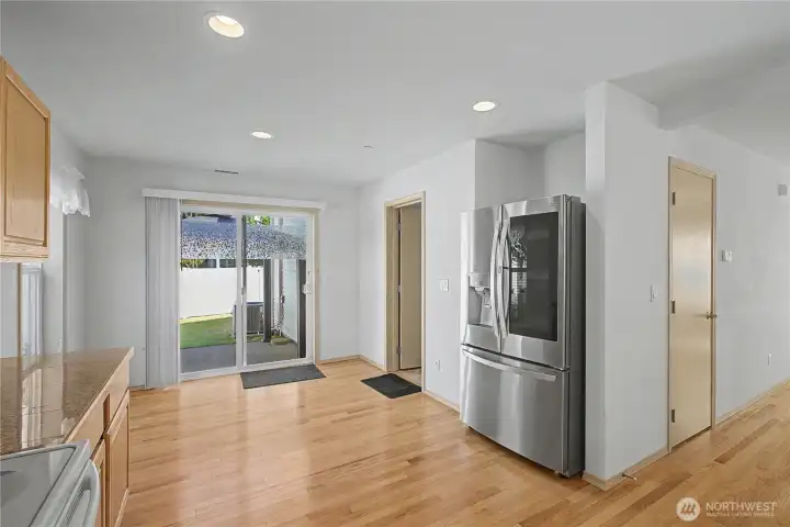 Kitchen with easting space with sliding door to your patio. A hallway to the left of refrigerator lead to pantry, utility and garage.