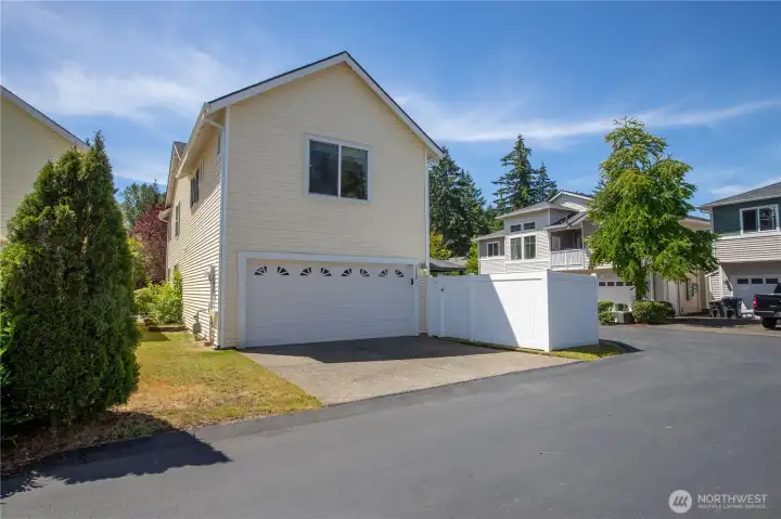 Notice extra parking behinf the garage and gate to side fenced yard.