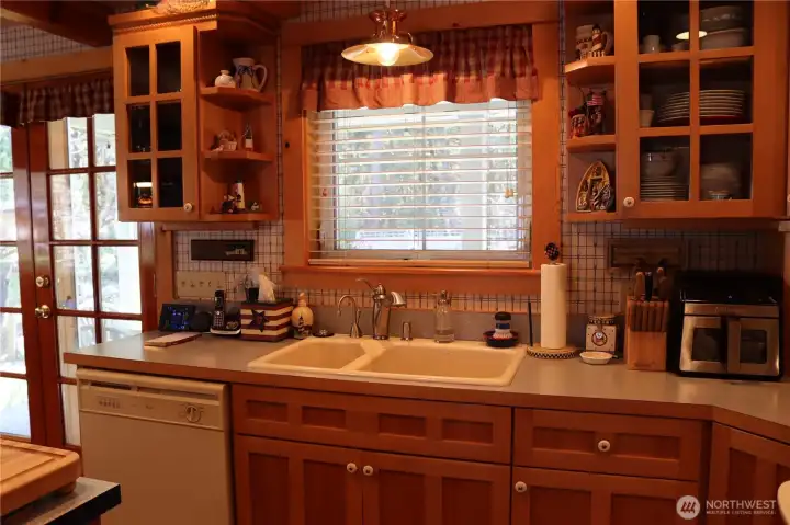 Kitchen sink overlooking covered back porch and firepit