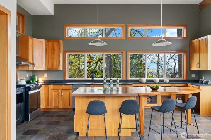 Kitchen with cherry cabinets, stainless appliances, quartz and concrete counters