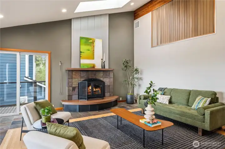 Living room with vaulted ceilings, skylights and lake views