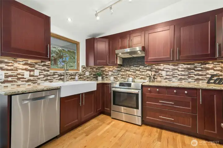 Farm sink, quartz counters, wood cabinets