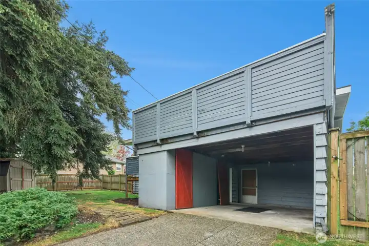 Carport or just add the garage door to complete. Rooftop deck above