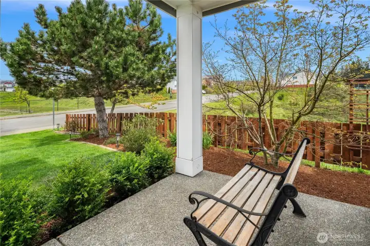 Peaceful covered porch with views to the North and open-space across the street.