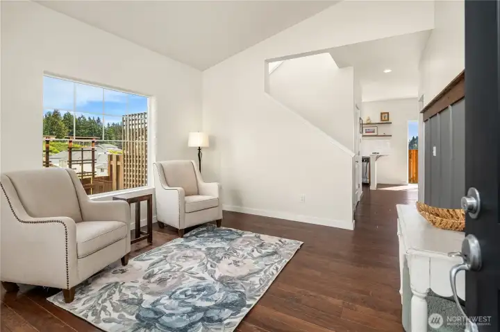Formal living room with accent wall and chair rail finishes