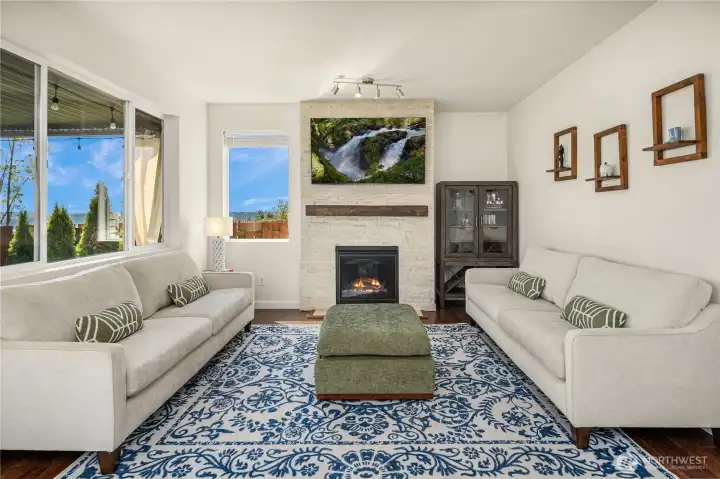 Great room with stone fireplace and wood mantle