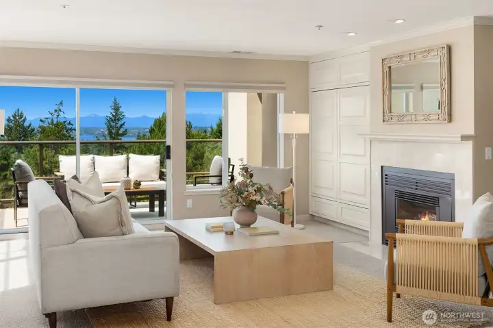 Living room with views, deck access and gas fireplace