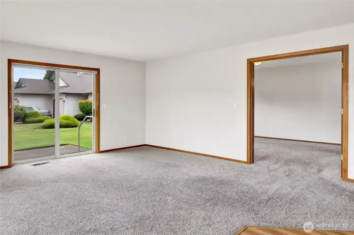 Just off the main living area, the doorway on the right opens to the private primary bedroom and ensuite bath. Just off the main living area, the doorway on the right opens to the private primary bedroom and ensuite bath.