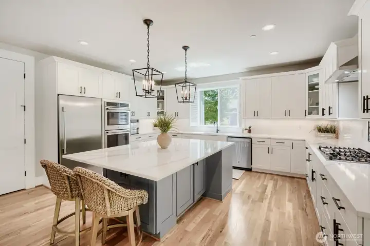 The kitchen island has cupboards, power and houses the microwave on the other side. The kitchen island has cupboards, power and houses the microwave on the other side.