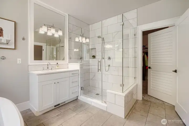 The walk in shower of the first primary bathroom. Door is leading to the walk in closet. The walk in shower of the first primary bathroom. Door is leading to the walk in closet.