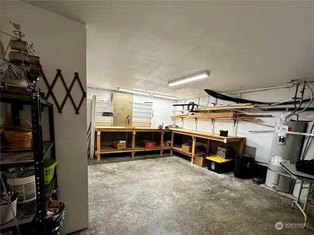 Workshop in basement complete with cabinet storage and shelves