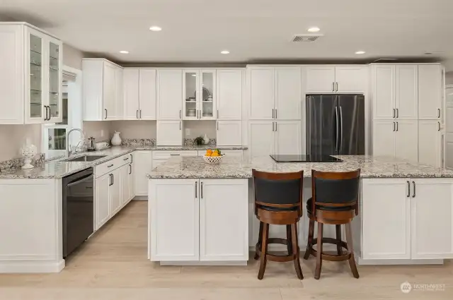 The kitchen wall was removed and the space opened up to become a 'Great Room'. The massive kitchen island offers abundant countertop space and loads of extra cabinet storage.
