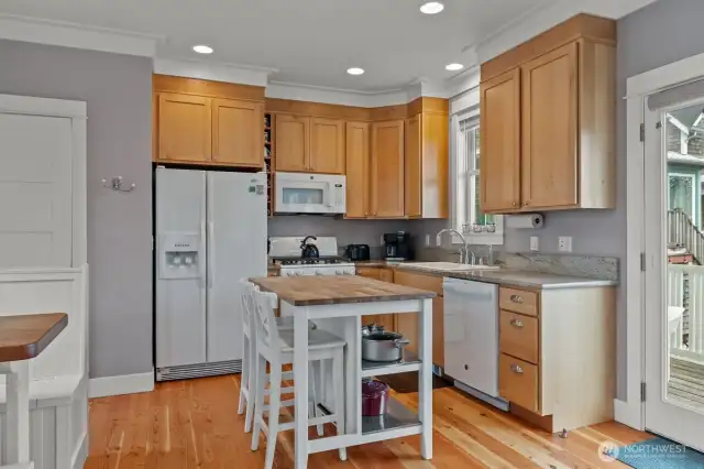 The kitchen counters are granite and the propane range is perfect for the stormy nights when the power goes out and you need to cook.  Off the kitchen/living space is a door to the front porch.