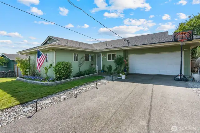 Front of home features two car garage and plentiful driveway parking