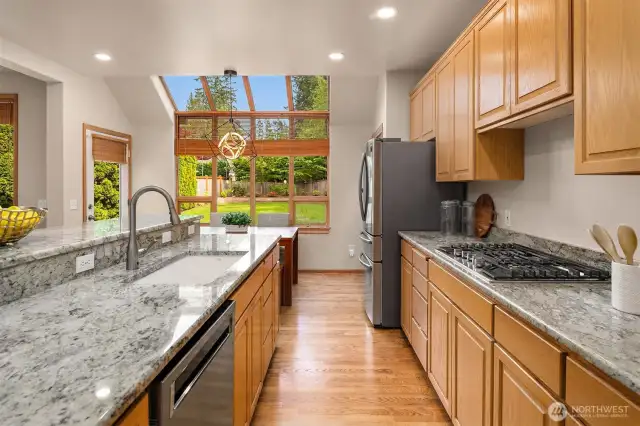 Featuring stainless steel appliances and granite slab countertops.