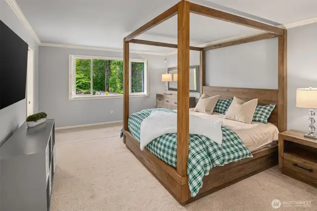 A roomy primary suite, offering views of the serene backyard.