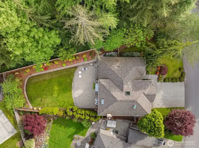 This 0.3-acre lot features a flat, fully fenced yard, offering privacy and the added benefit of public land next door.