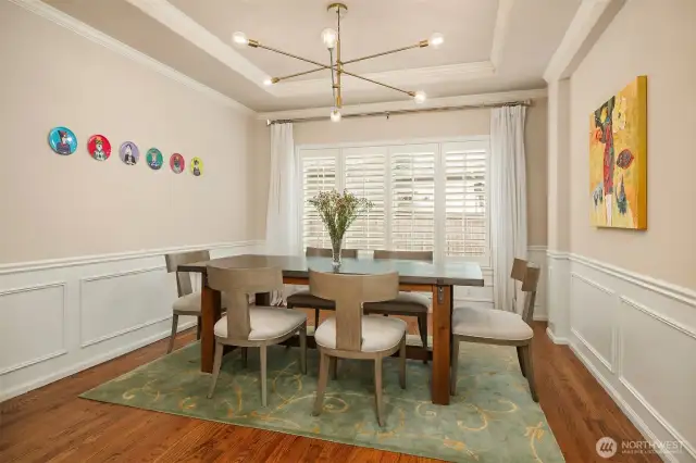 The spacious dining room features stylish new lighting and charming shutters.