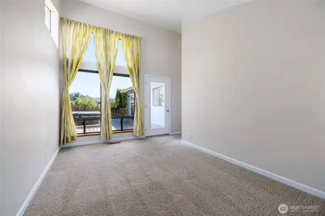 Corner bedroom with a floor to ceiling window. Door leads to the deck w/hot tub.