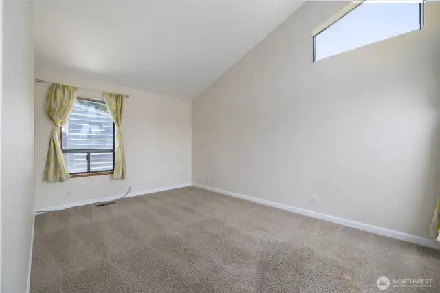 The corner bedroom has plenty of light and architectural elements that make the room visually appealing.